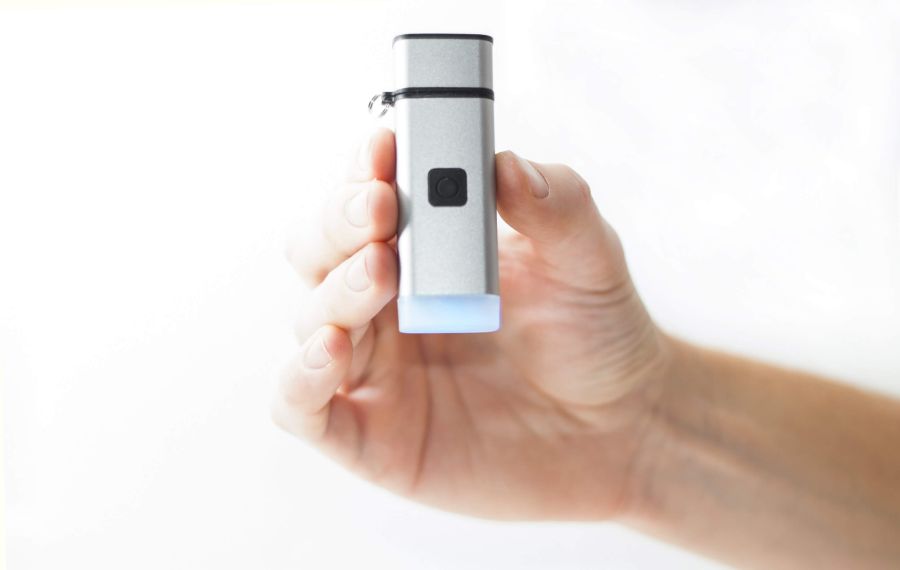 person handing iBac Breathalyzer Device - Portable Breath Alcohol Device
